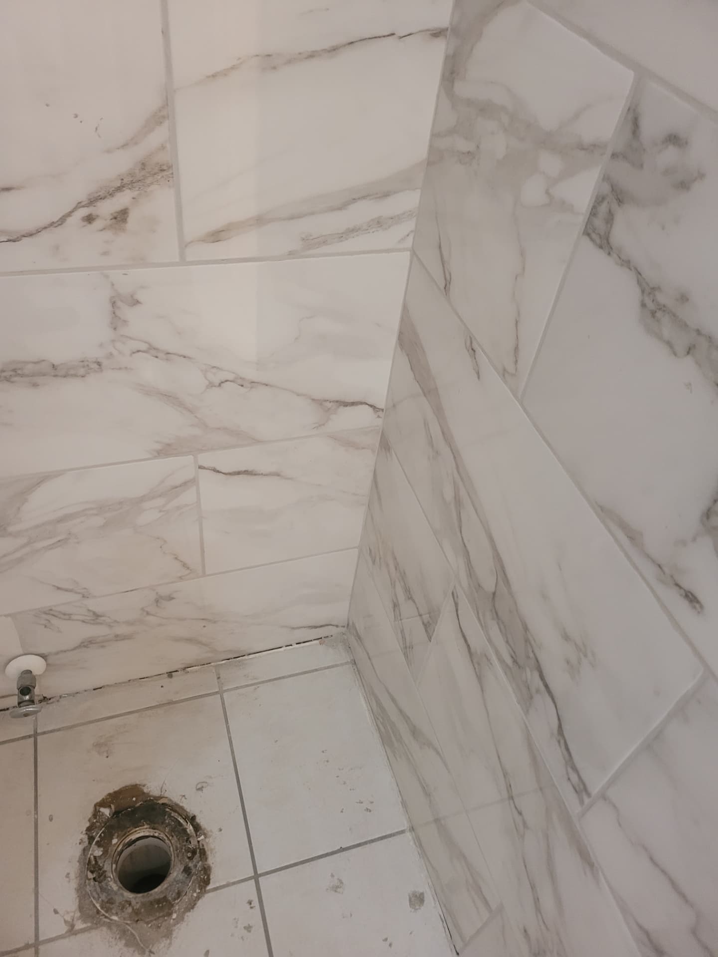 Marble-look porcelain tile installed on shower walls