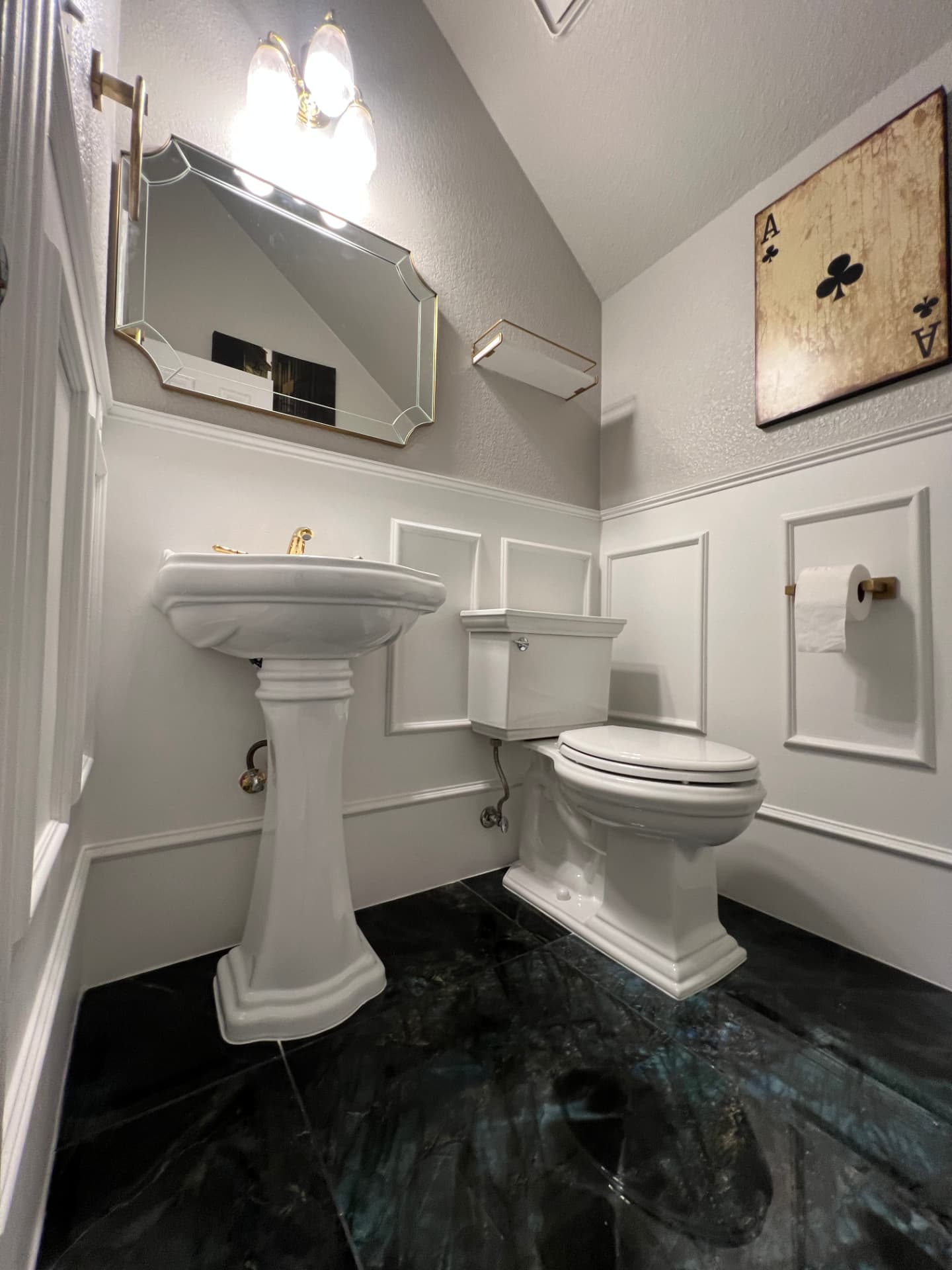 Remodeled powder room with wainscoting and stone floor