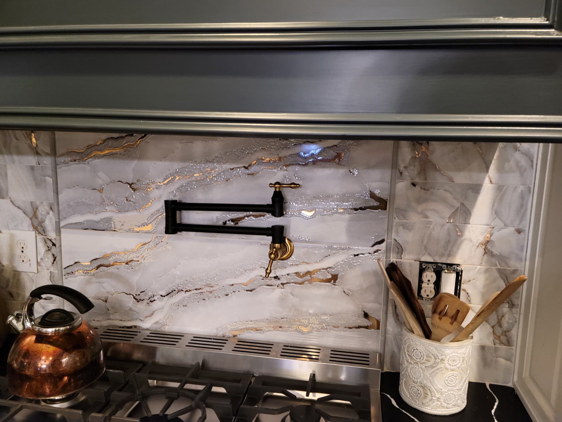 Stone backsplash behind a pro-style range